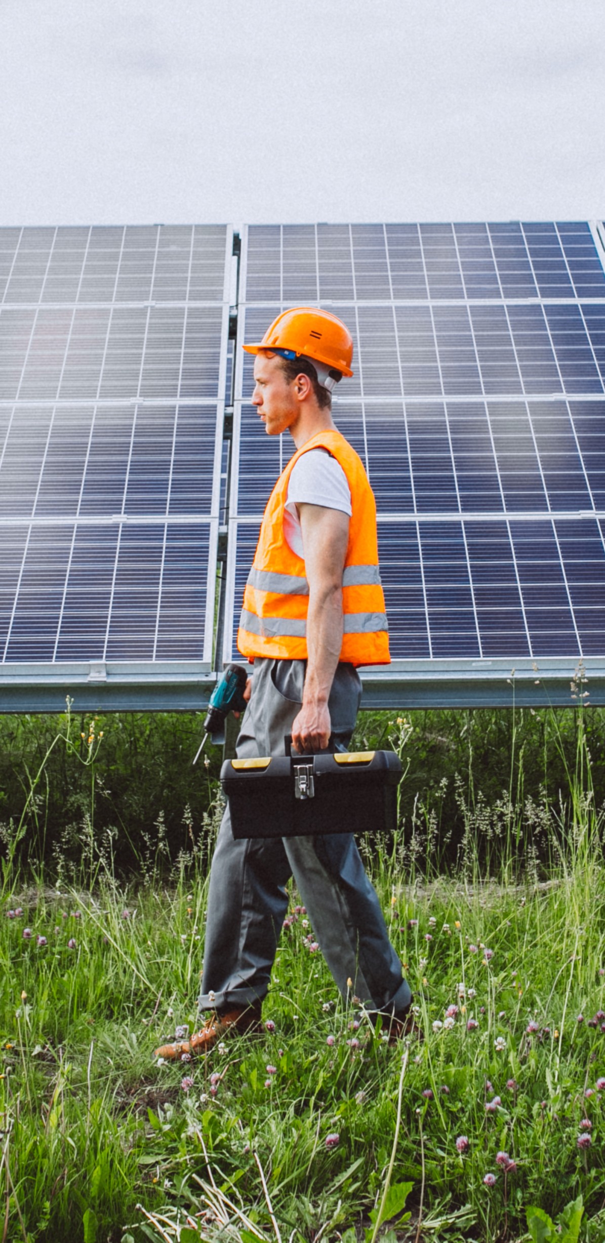 Man worker in the firld by the solar panels